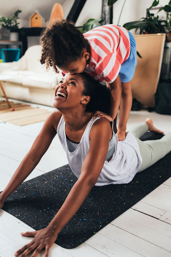 woman doing yoga with her child after hernia repair